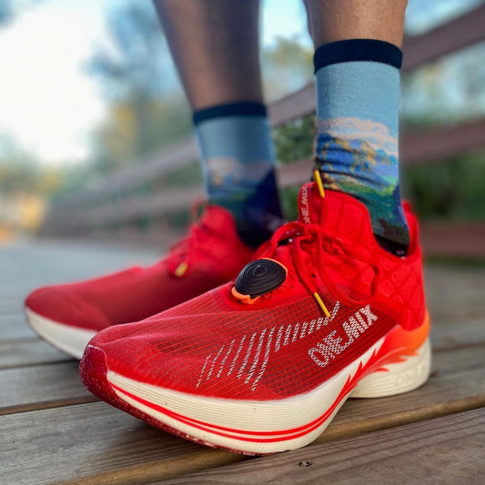 A pair of red running shoes with carbon fiber insoles